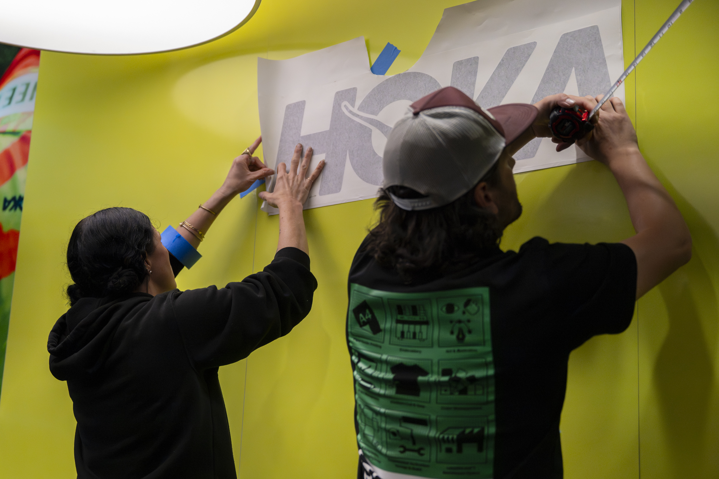 Installing contour-cut HOKA vinyl at Festival of Miles